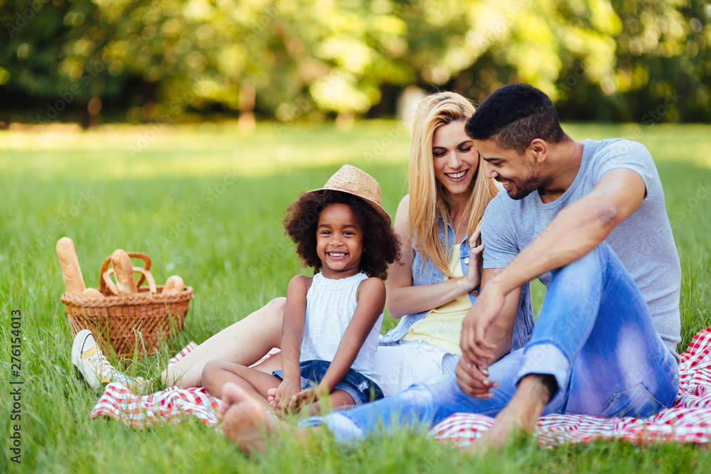 Picture of lovely couple with their daughter having picnic Picture of lovely couple with their daughter having picnic