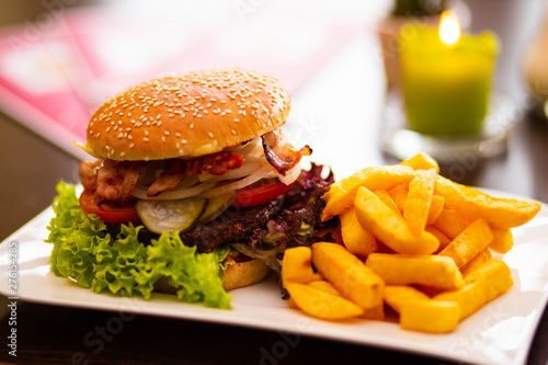 Fotografie Close Up of Burger with Fries on table in Bistro