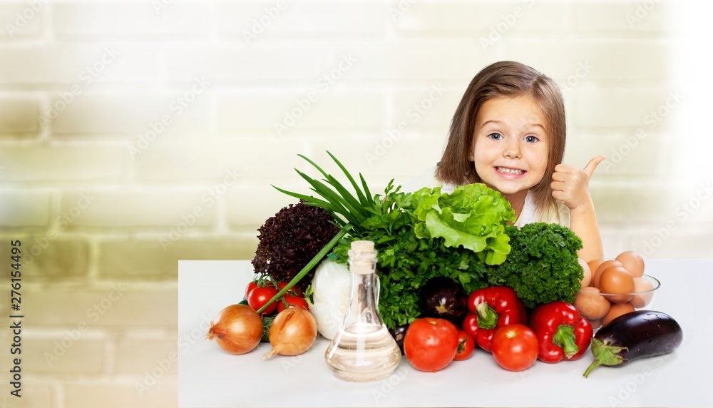 Cute little girl with vegetables in kitchen Cute little girl with vegetables in kitchen