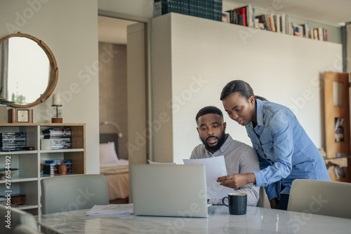 Young African American couple doing their online banking at home