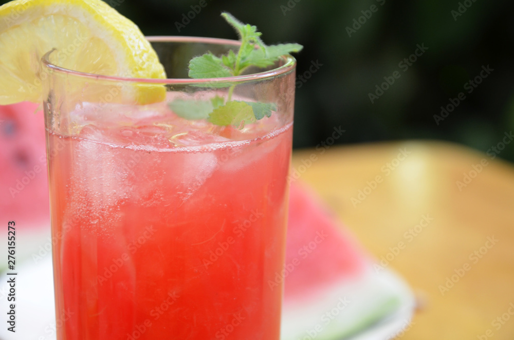 Colorful tropical fresh watermelon smoothie summer drinks in the glasses on wood table background. Refreshing watermelon coсtail with slimon of green foliage. The concept of leisure, travel Colorful tropical fresh watermelon smoothie summer drinks in the glasses on wood table background. Refreshing watermelon coсtail with slimon of green foliage. The concept of leisure, travel