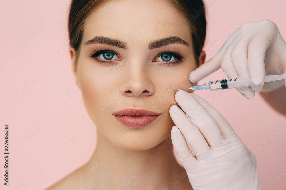 beauty injections into beautiful face. smoothing of mimic wrinkles near lips, biorevitalization on pink beauty injections into beautiful face. smoothing of mimic wrinkles near lips, biorevitalization on pink