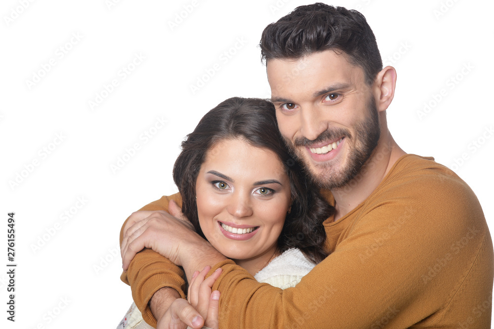 Portrait of happy young couple smiling and hugging on white background Portrait of happy young couple smiling and hugging on white background