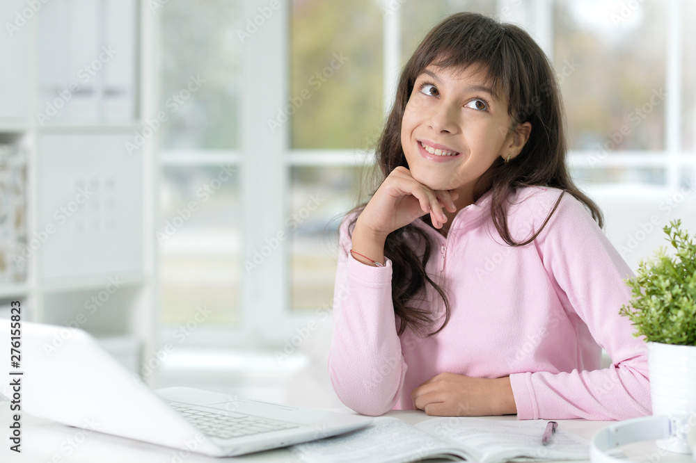 Portrait of beautiful girl with laptop studying at desk Portrait of beautiful girl with laptop studying at desk