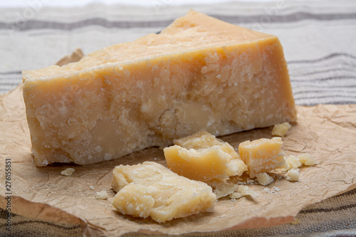 Piece of Italian original aged Parmesan cheese and cheese knife close up