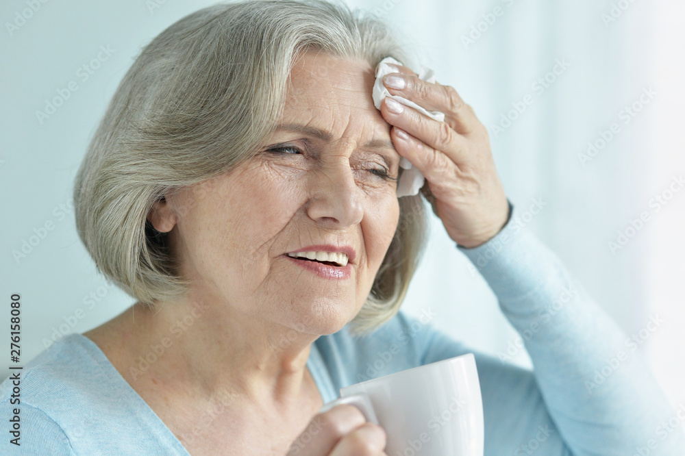 Portrait of senior woman with headache holding hand on head Portrait of senior woman with headache holding hand on head