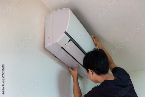 Technician you are checking air conditioning in white room photo