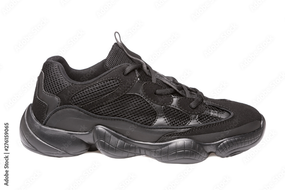 One black sneaker, side view, for running or walking, on a white background