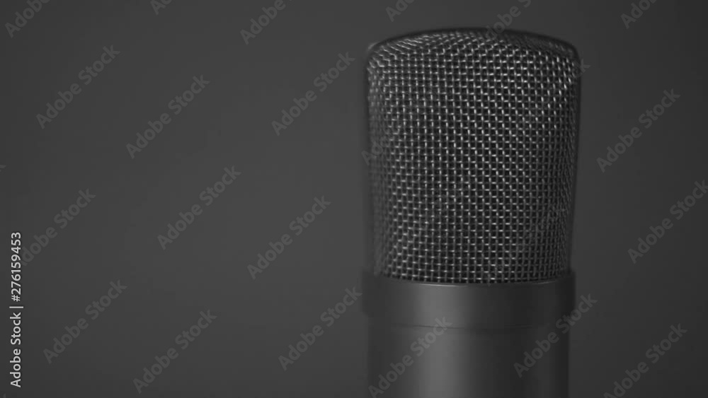 Podcasting audio large diaphragm mic rotating with light, product shot Podcasting audio large diaphragm mic rotating with light, product shot
