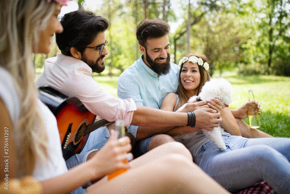 Happy young friends having picnic in the park Happy young friends having picnic in the park