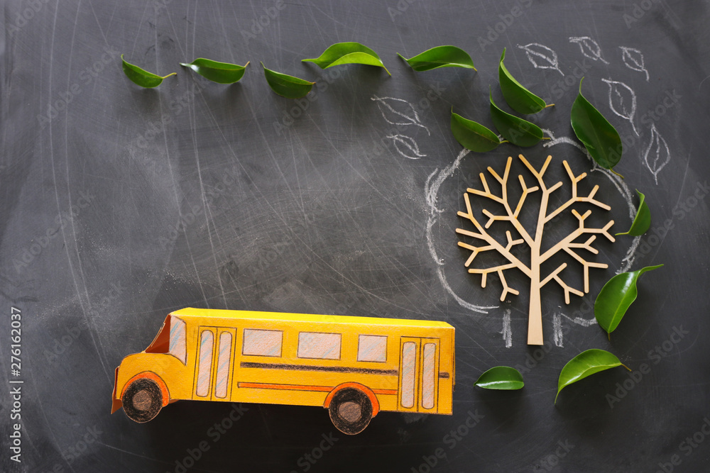 education and back to school concept. Top view photo of school bus next to  tree with autumn leaves over classroom blackboard background. top view,  flat lay Stock Photo | Adobe Stock
