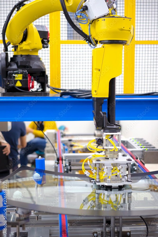 Automation concept: View of inspection unit on industrial robot arm in automative windshield manufacture plant Automation concept: View of inspection unit on industrial robot arm in automative windshield manufacture plant