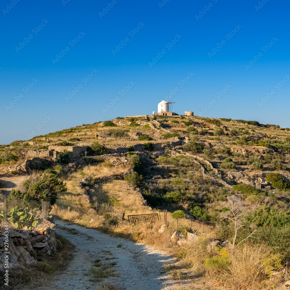 Beautiful greeek countryside landscape with traditional cycladic windmill on Paros island, Greece