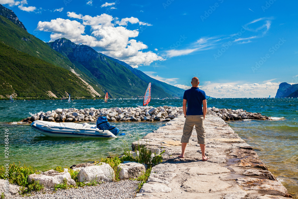 man standing on a pier, Garda lake