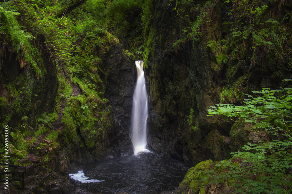 The Stanley Ghyll Force Waterfall (called also Clear Force) in a enchanted green and wild forest. Lake District National Park, Cumbria, England, UK.