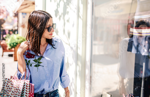 Young woman in shopping looking for presents. Consumerism, fashion, lifestyle concept