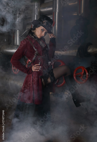 Pretty young steampunk woman over industrial background