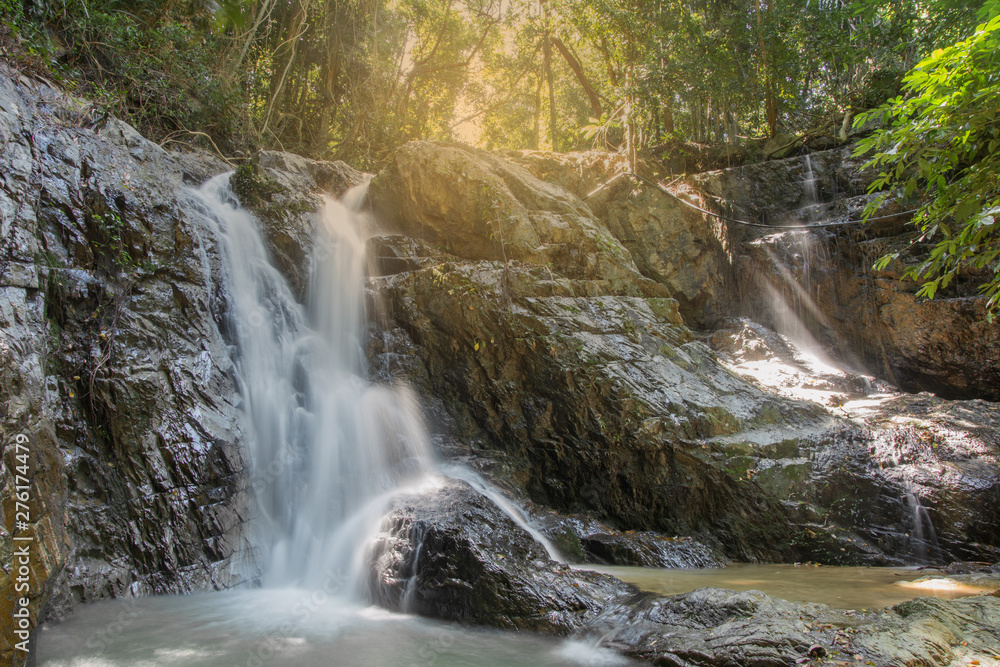 Streams in the tropical rainforest washed down from the rocks to form a beautiful waterfall Streams in the tropical rainforest washed down from the rocks to form a beautiful waterfall