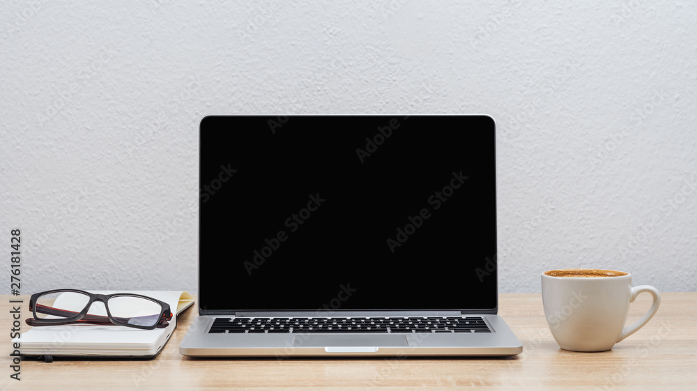Laptop screen on the desktop, notebook, glasses and a cup of coffee. Mock up. Laptop screen on the desktop, notebook, glasses and a cup of coffee. Mock up.