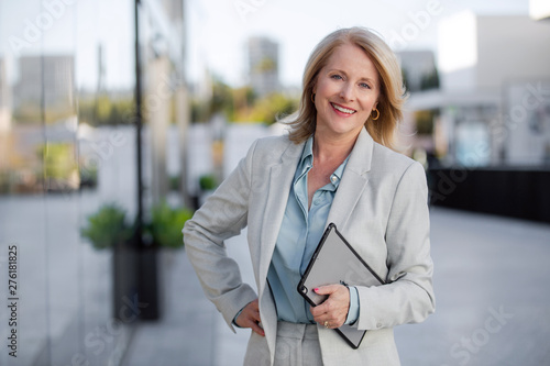 Mature business executive professional woman portrait, in suit outside of office in business district