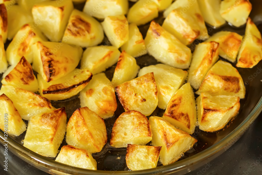 Delicious baked potatoes on glass plate, closeup Delicious baked potatoes on glass plate, closeup