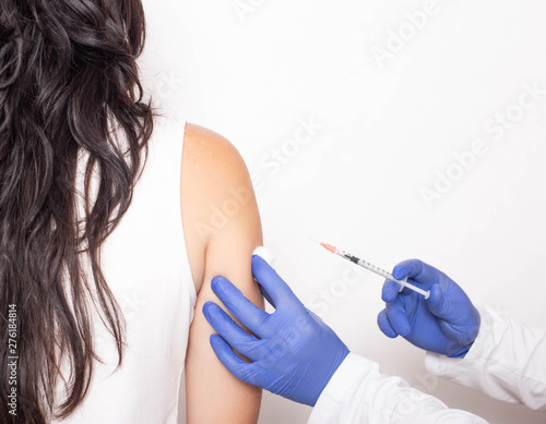 Allergist doctor injects against allergies to a young girl, a medical. Allergen-specific immunotherapy, copy space
