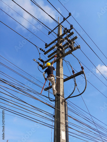 Electrical Technician work maintenance and Repair about Distribution Electrical Power System Equibment on Riser pole 22 kV High Voltage  photo