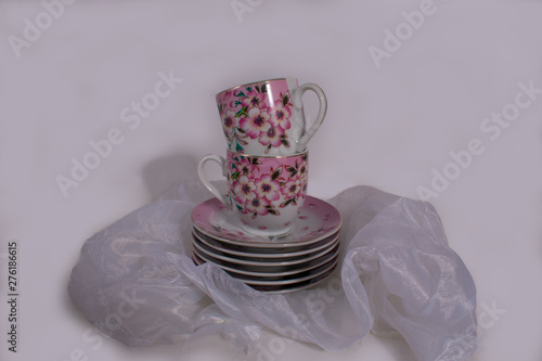 Obraz na plátně Tea set on a beige cape on a white background