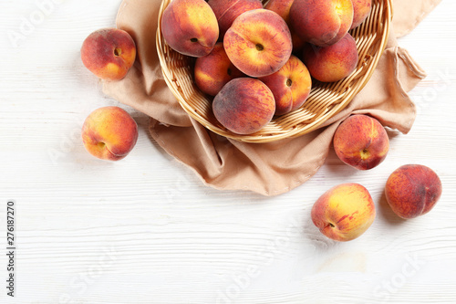 Bunch of ripe organic peaches in pile on wood textured table. Local produce harvest heap. Clean eating concept. Background, top view, close up, copy space, flat lay.
