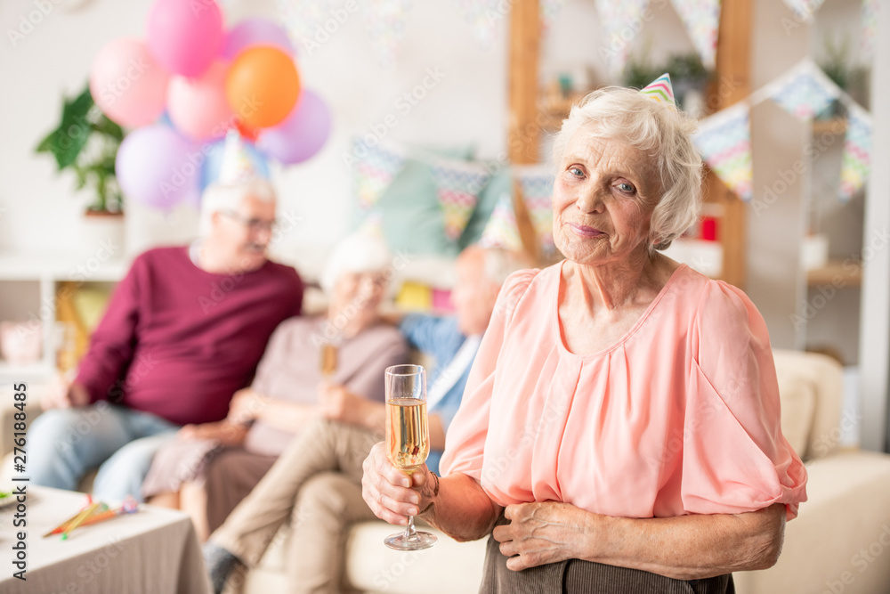 Gracious senior female with flute of champagne Gracious senior female with flute of champagne