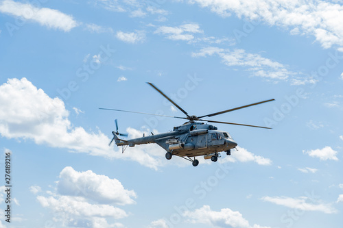 Fototapeta Naklejka Na Ścianę i Meble -  Flying military transport helicopter special for army soldier in fight war. Military soldier volant in transport helicopter above clean blue sky. Helicopter is military transport to army soldier