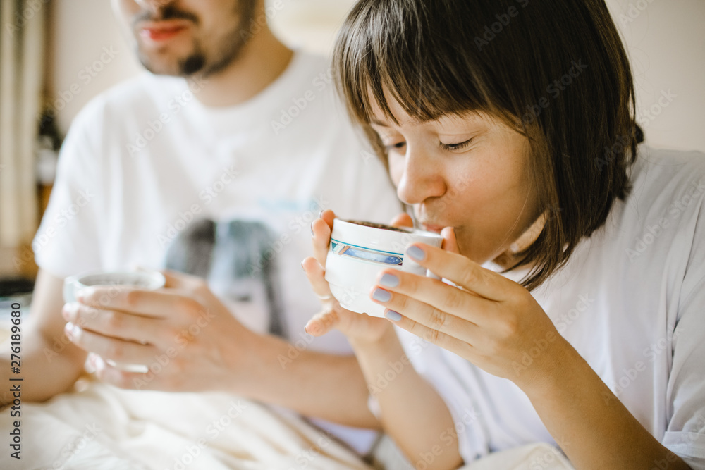 Girl drinking hot coffee in the morning with boyfriend Girl drinking hot coffee in the morning with boyfriend