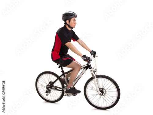 Sideways profile of a guy riding a mountain bike, full length shot over white background