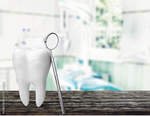 Big tooth and dentist mirror  medical concept