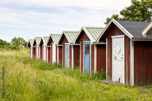 Fishing sheds among wild grasses in Kivik, Sweden. © tomalv