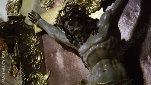 Close up view of holy cross hanging in the church. Crucify, religion and belief concept. Crucifix, jesus on the cross in church with ray of light