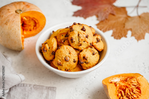 Pumpkin cookies with chocolate chips made from cake mix in a white ceramic bowl.