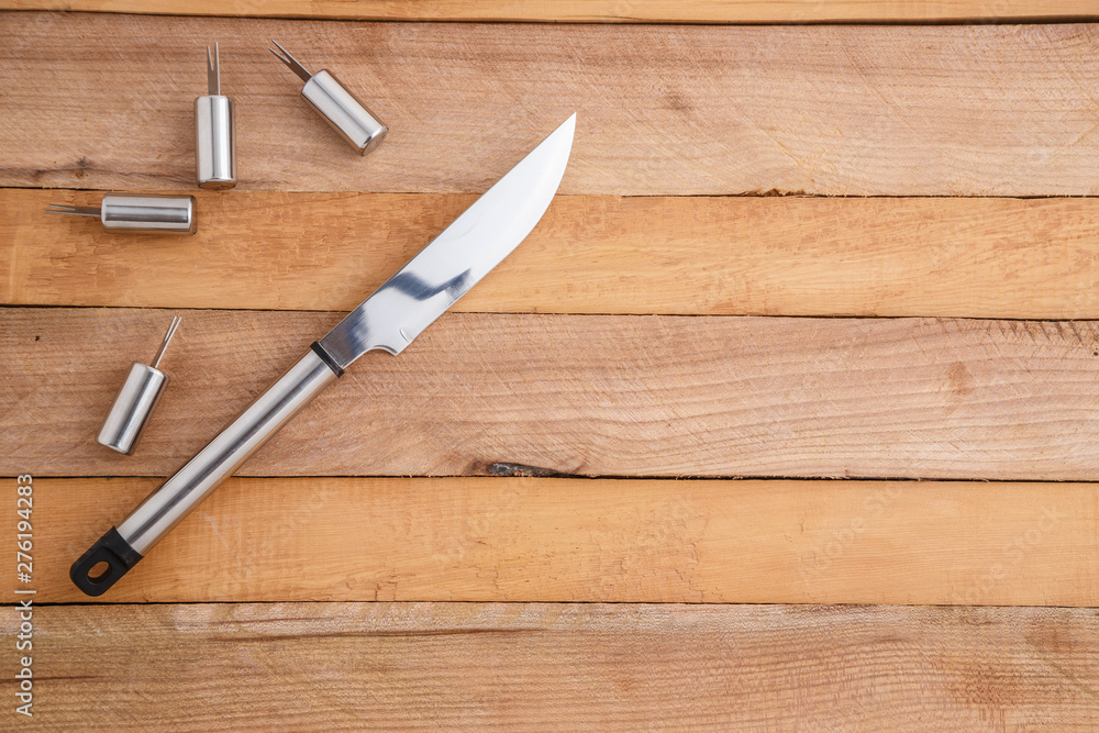 metal set for cutting meat and grilling on wooden background metal set for cutting meat and grilling on wooden background