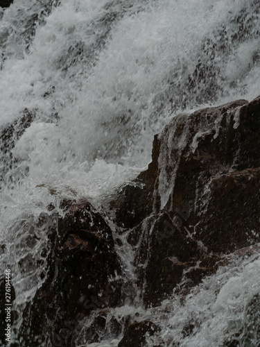 Stormy waters of the northern waterfall in a rocky gorge on the shores of the cold sea