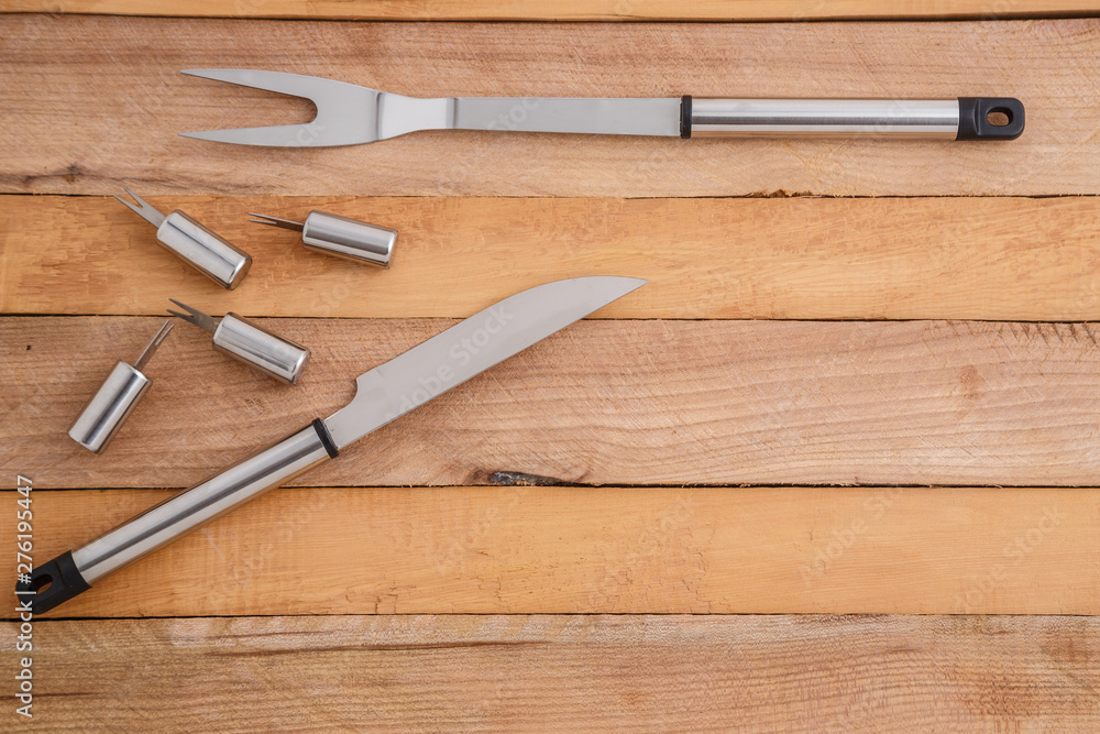 metal set for cutting meat and grilling on wooden background metal set for cutting meat and grilling on wooden background