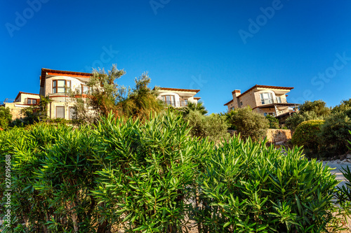 Beautiful houses on a green hill on a sunny day.