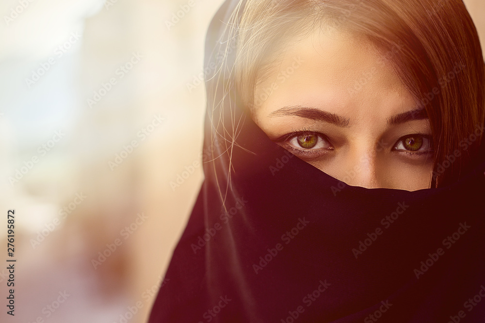 beautiful eyes of Muslim women with face covered in a black hijab in the Eastern city beautiful eyes of Muslim women with face covered in a black hijab in the Eastern city