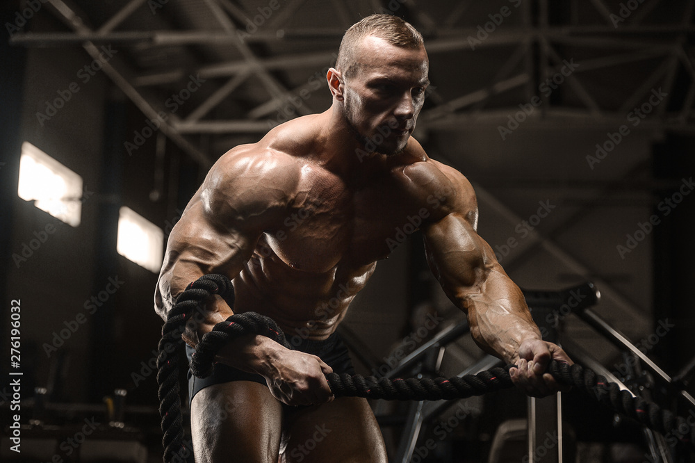 muscular bodybuilder fitness men doing arms exercises in gym muscular bodybuilder fitness men doing arms exercises in gym
