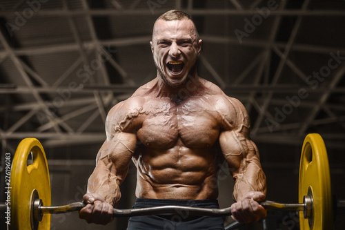 muscular bodybuilder fitness men doing arms exercises in gym © antondotsenko
