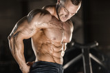 muscular bodybuilder fitness men doing abs exercises in gym