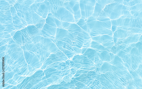 bright ripple surface of light blue swimming pool with sun reflect view from top see through floor ,abstract clean water glare detail for texture background or wallpaper