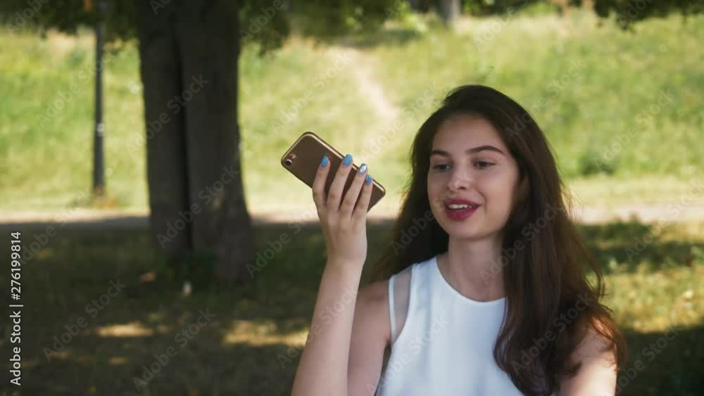 girl using smart phone voice recognition, dictates thoughts, voice dialing message at night evening home student model young in cafe audio ai speech girl using smart phone voice recognition, dictates thoughts, voice dialing message at night evening home student model young in cafe audio ai speech