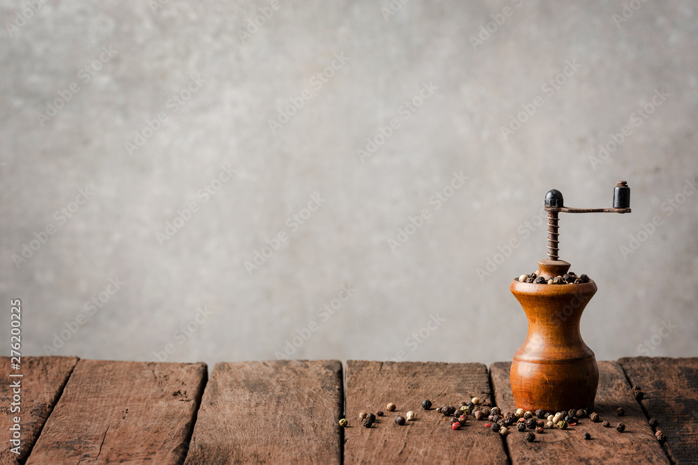 Retro pepper mill on wooden table Retro pepper mill on wooden table