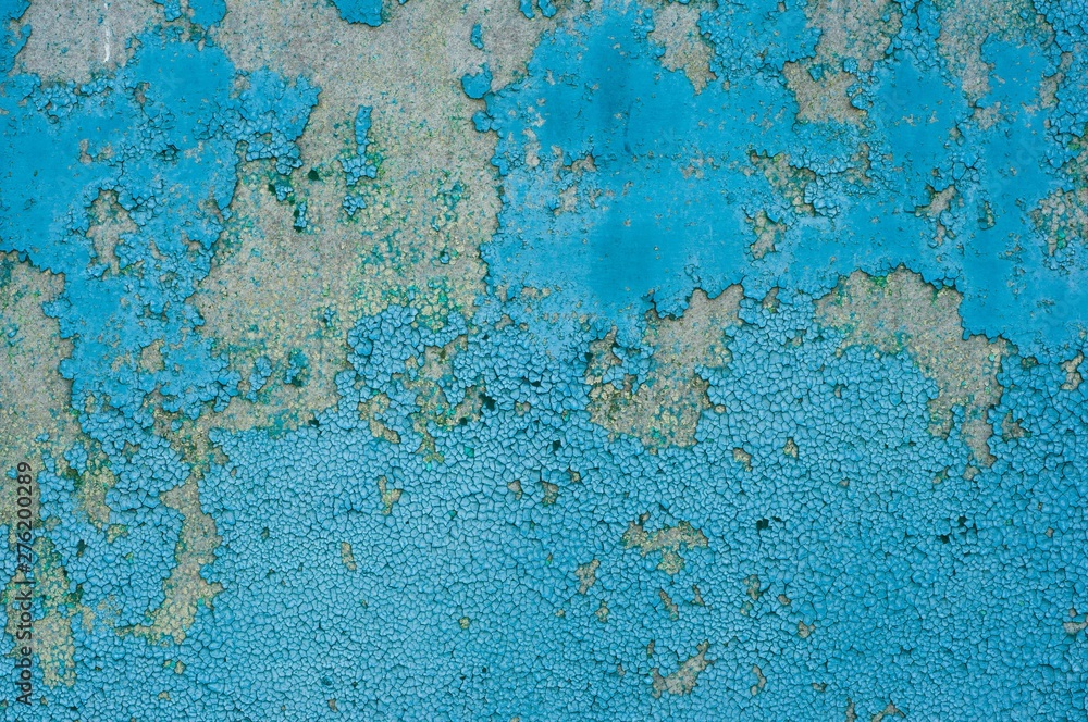 Old cracked blue paint on concrete