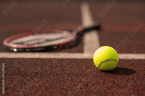 Tennis ball on sports playground on stadium by white line © pressmaster